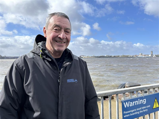 John Mills, Mate standing at Pier Head terminal with the River in the background.